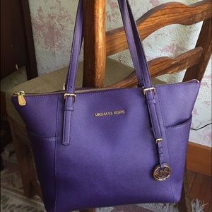 Purple Michael Kors shoulder bag.