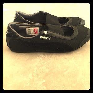 Puma lifestyle flats in black. Slightly worn