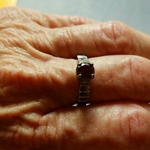"Silver " with a red stone ring