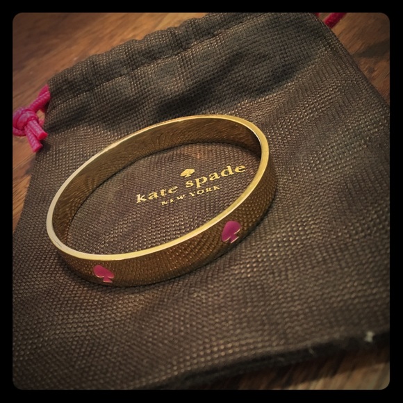 Kate Spade Gold bangle bracelet with pink accents
