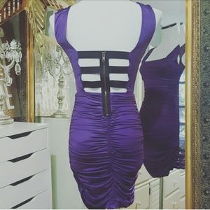Fitted purple dress with black banded open back.