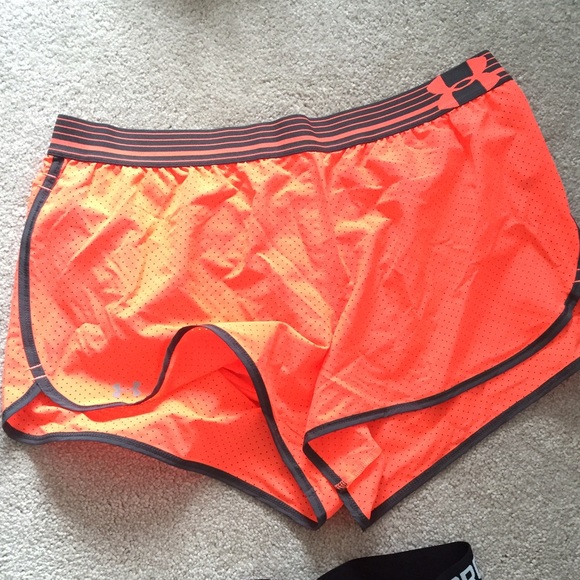UA neon orange shorts