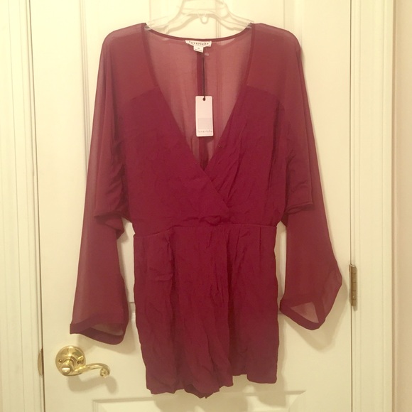 Maroon romper with sheer sleeves and back.