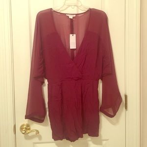 Maroon romper with sheer sleeves and back.