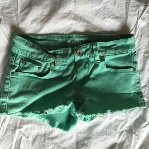 Light green denim shorts.