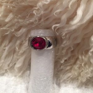 Silver tone ring with a red crystal stone