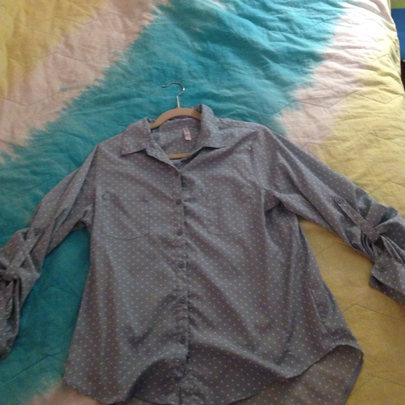 Blue button up shirt with white polka dots.