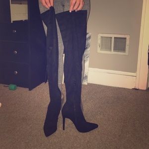 Tall black over the knee heel boots.