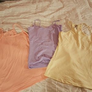 Pink, light purple, and pastel yellow tanks