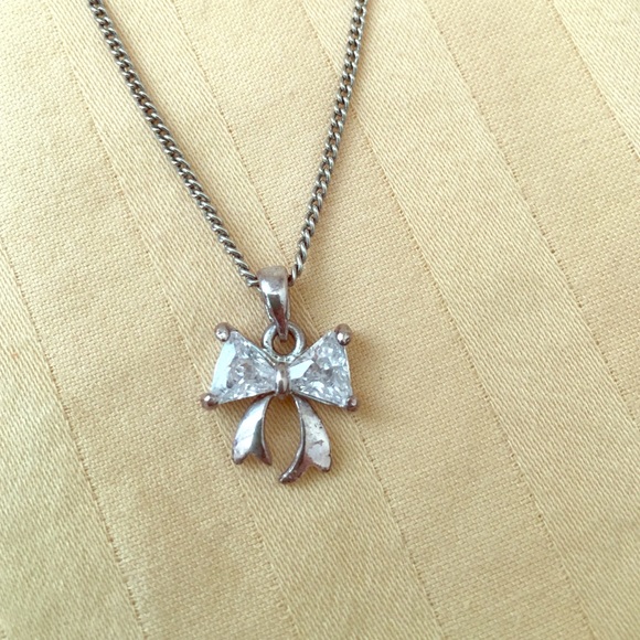 Silver bow necklace.