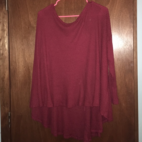 Dark red, loose fitting sweater.