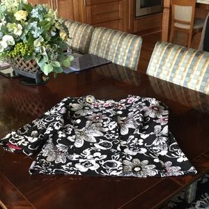 Sequins detail the neck and front of this jacket.