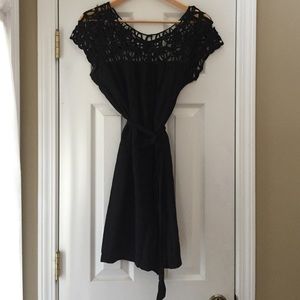 Black dress with crochet detail at neck. Large