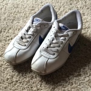 White and blue nike tennis shoes