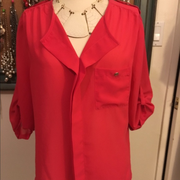 Coral 100% polyester 3/4 sleeves.  Tunic style top