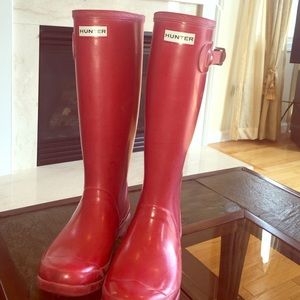 Tall red Hunter rain boots.