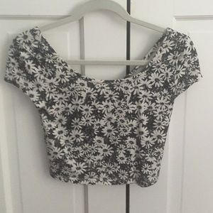 Cropped, short sleeve, flower patterned shirt.
