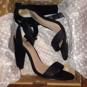 Strapped black heels.