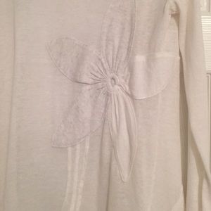 White cardigan with flowers. Pockets on front