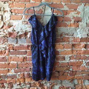 Black cocktail dress with ruffles and pockets