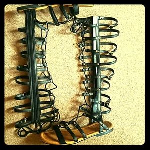 Tall (Calve high) black gladiator sandals.