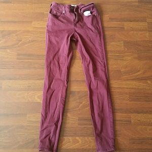 Maroon jeans.