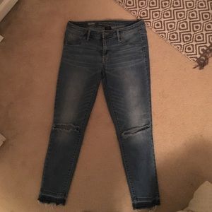 Jean capris with holes at the knees