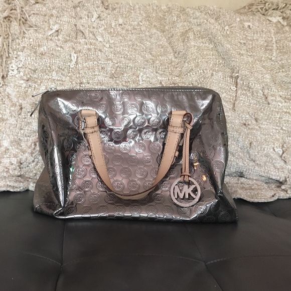 Authentic Metallic Micheal Kors hand bag.