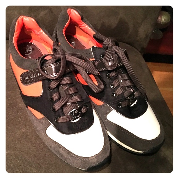 Michael Kors orange and white sneakers.