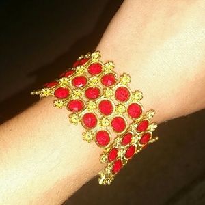Gold bracelet with red accents