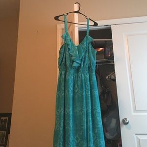 Blue dress, holter. Style.  Small spot in front.