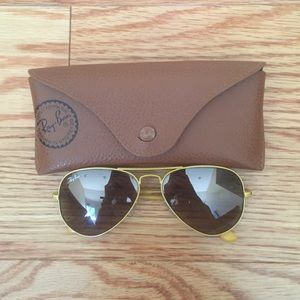 Yellow framed Ray-Ban Aviators.