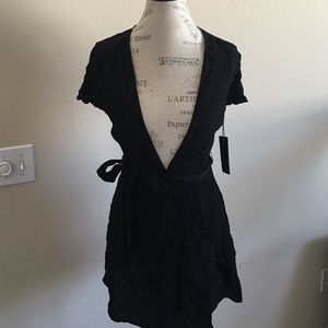Adorable low cut black wrap mini dress.