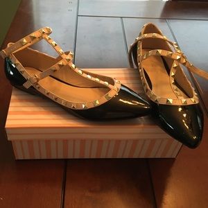 Black and nude flats with gold detailing