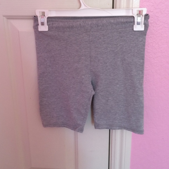 Grey mid-thigh shorts.