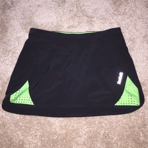 Black and green Reebok tennis skort