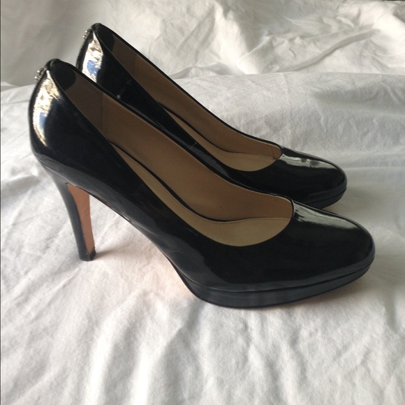 Black patent leather Coach pumps