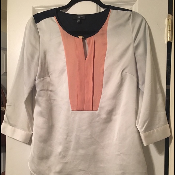 Silky blouse with peach and navy detail.