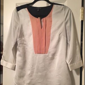 Silky blouse with peach and navy detail.