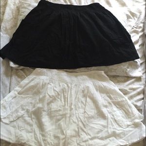 Two skirts; one black, one white.