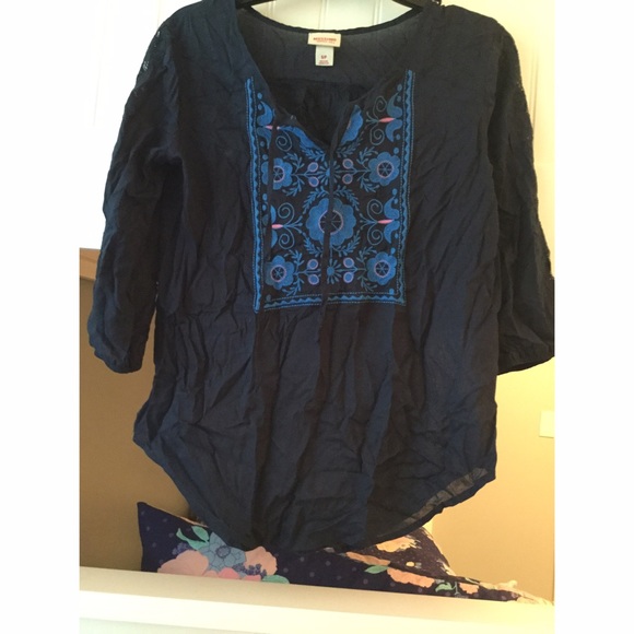 Navy top, with design on the front, size small.