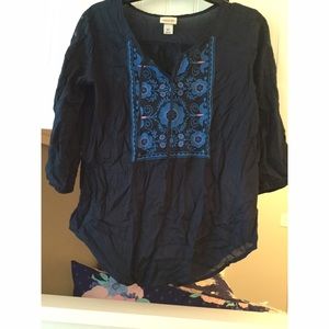 Navy top, with design on the front, size small.
