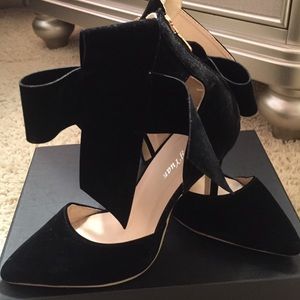 Black suede bow pumps
