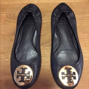 Tory Burch black leather flats; gold emblem.