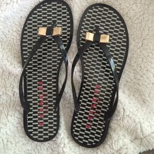 Coach flip flops with gold bow