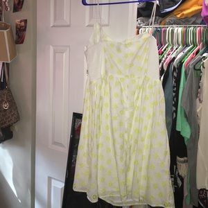 White dress with yellow green eyelet flowers.