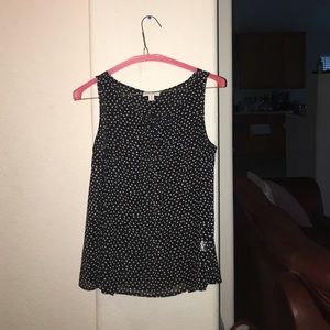 Sleeveless black and white poka dot blouse