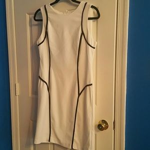 White sleeveless knit dress with black piping trim