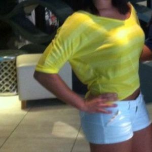 Yellow shirt. 3/4 length sleeves.