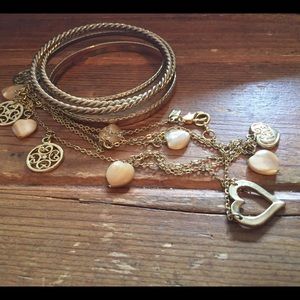 Set of 5 gold bangles and gold heart necklace